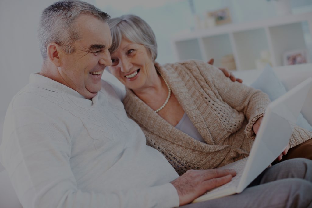 Elderly couple on laptop together